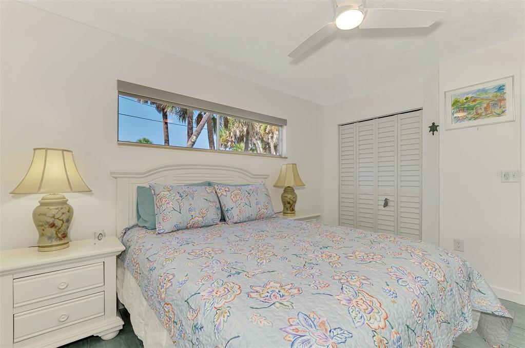 2985 North Beach Road, Unit C53 Englewood, FL 34223 - Photo 28 of 67 a bedroom with a large bed and a walk in closet