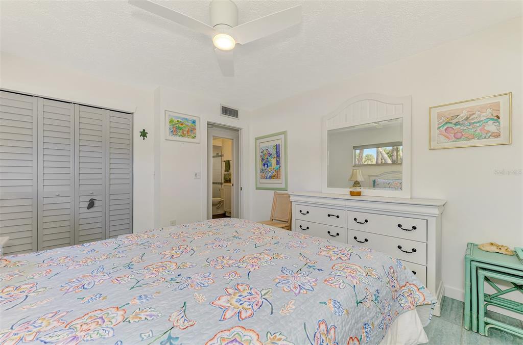 2985 North Beach Road, Unit C53 Englewood, FL 34223 - Photo 30 of 67 a bedroom with a bed and a dresser