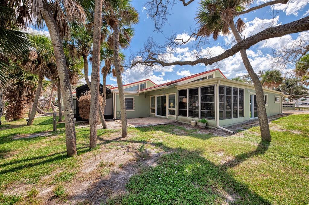 2985 North Beach Road, Unit C53 Englewood, FL 34223 - Photo 3 of 67 a view of a house with backyard porch and sitting area