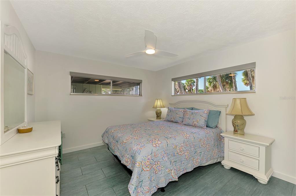 2985 North Beach Road, Unit C53 Englewood, FL 34223 - Photo 31 of 67 a bedroom with a bed and a night stand