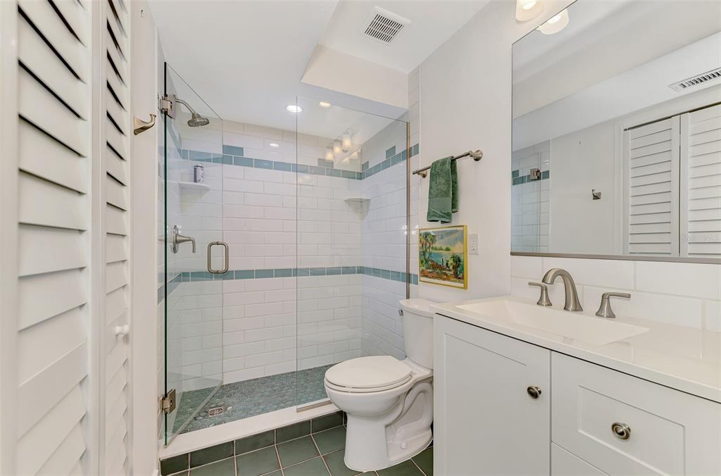 2985 North Beach Road, Unit C53 Englewood, FL 34223 - Photo 32 of 67 a bathroom with a sink a toilet and shower