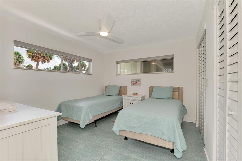 2985 North Beach Road, Unit C53 Englewood, FL 34223 - Photo 34 of 67 a bedroom with two beds and painting on the wall