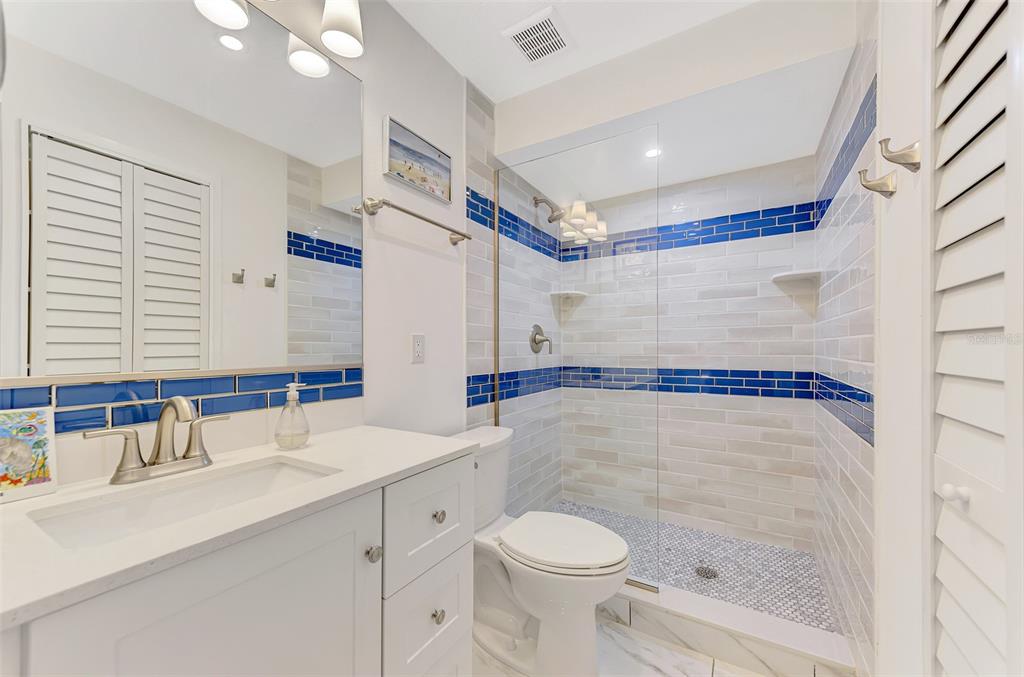 2985 North Beach Road, Unit C53 Englewood, FL 34223 - Photo 35 of 67 a bathroom with a sink toilet and shower