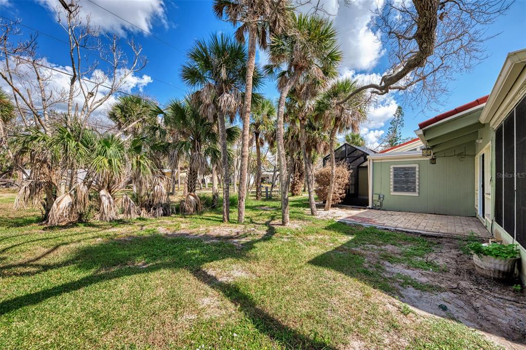 2985 North Beach Road, Unit C53 Englewood, FL 34223 - Photo 38 of 67 a backyard of a house with outdoor seating and trees