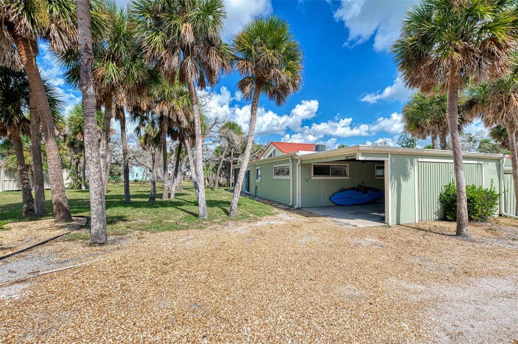 2985 North Beach Road, Unit C53 Englewood, FL 34223 - Photo 5 of 67 a view of a house with a yard and tree s