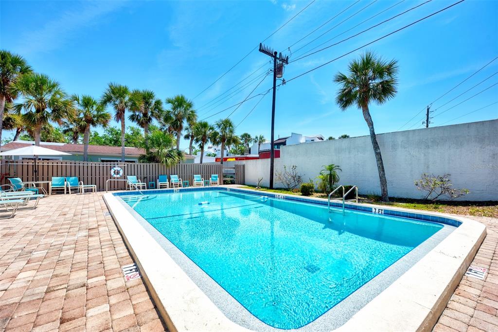 2985 North Beach Road, Unit C53 Englewood, FL 34223 - Photo 56 of 67 a view of a swimming pool with a chair and tables