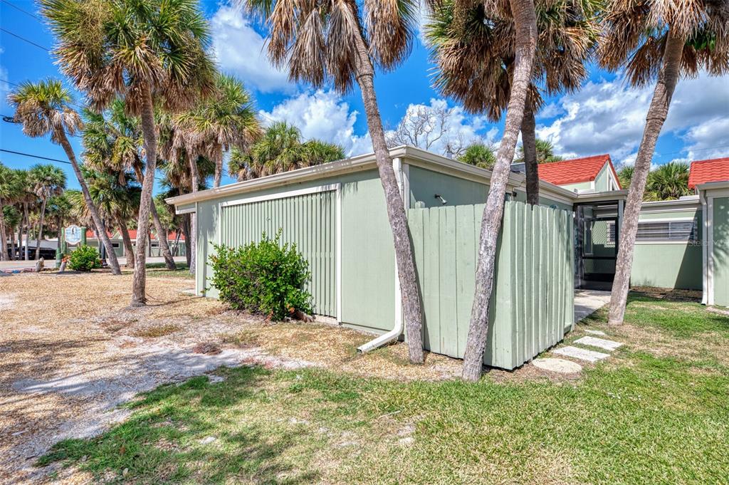 2985 North Beach Road, Unit C53 Englewood, FL 34223 - Photo 60 of 67 a view of a house with a yard and palm trees