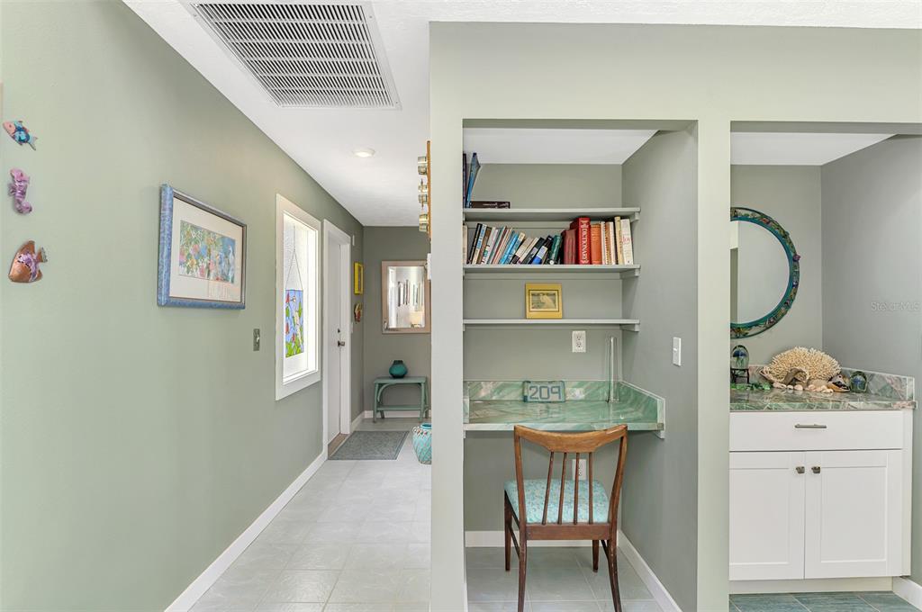 2985 North Beach Road, Unit C53 Englewood, FL 34223 - Photo 9 of 67 a workspace with furniture and a book shelf