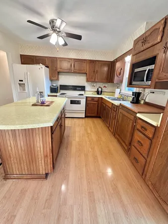 a view of kitchen with furniture and wooden floor