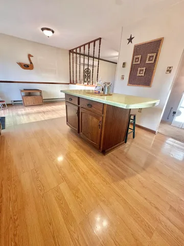 a large kitchen with stainless steel appliances granite countertop a stove and a sink
