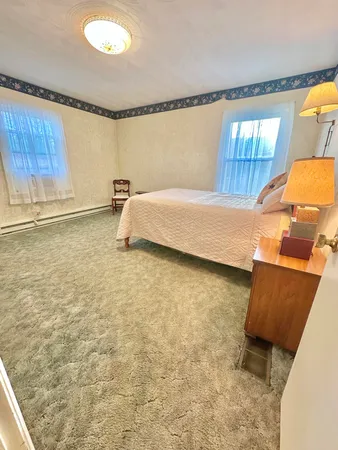 a bed room with a bed and a window