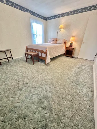 a living room with a table and chairs