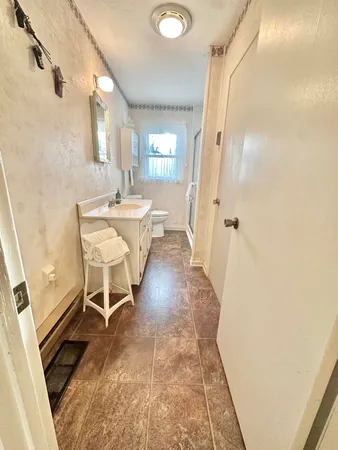 a bathroom with a glass shower door and a window