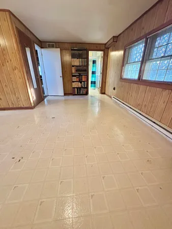 a bedroom with a bed and a mirror