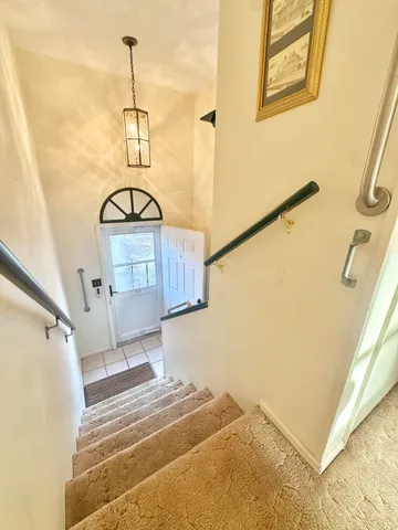 a living room with a couch and chandelier