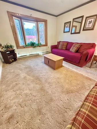 a bedroom with furniture and a large window