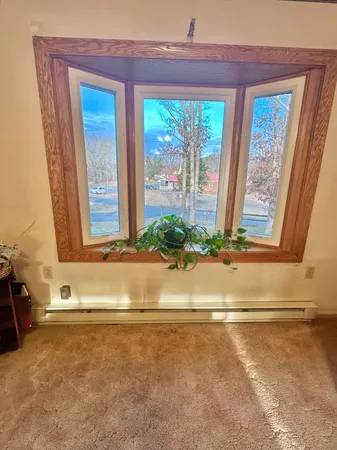 a kitchen with stainless steel appliances granite countertop a stove a sink dishwasher and a refrigerator with wooden floor