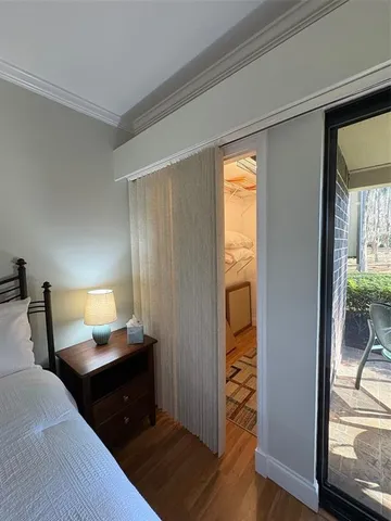 a large bedroom with a bed window and a television