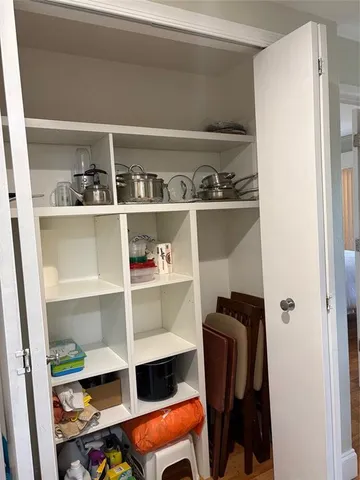 a view of walk in closet with clothes and shoes