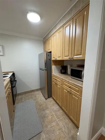 a kitchen with refrigerator and window