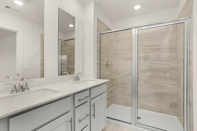a bathroom with a shower sink and mirror