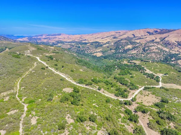 a view of a mountain with a yard