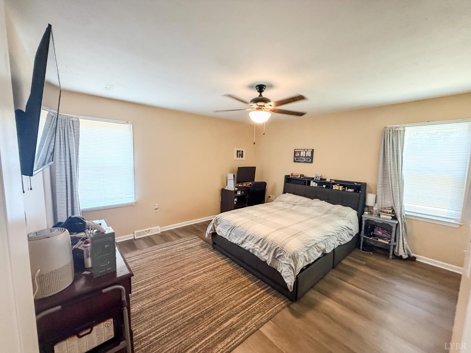 95 Midgett Farm Road Concord, VA 24538 - Photo 13 of 20 a bedroom with a bed and a chandelier