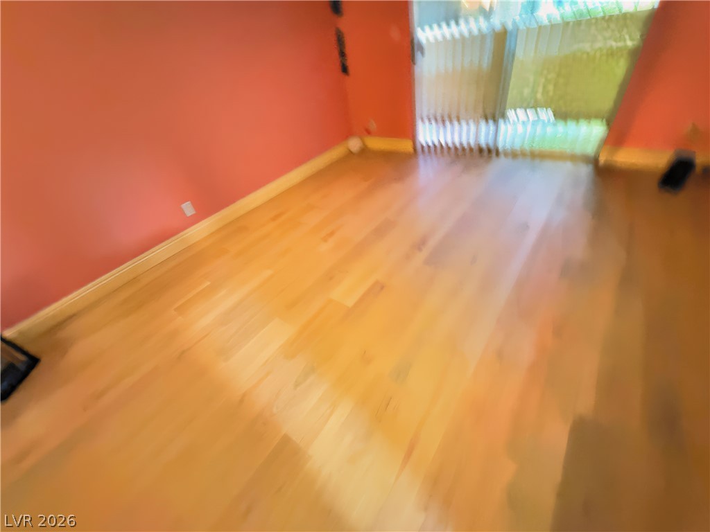 1852 North Decatur Boulevard, Unit 101 Las Vegas, NV 89108 - Photo 11 of 45 Rich wood flooring anchors this versatile space, highlighted by sliding glass doors.