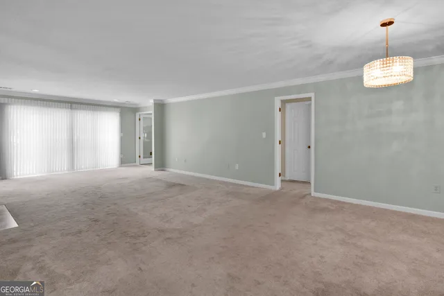 a view of an empty room with a fireplace and a window