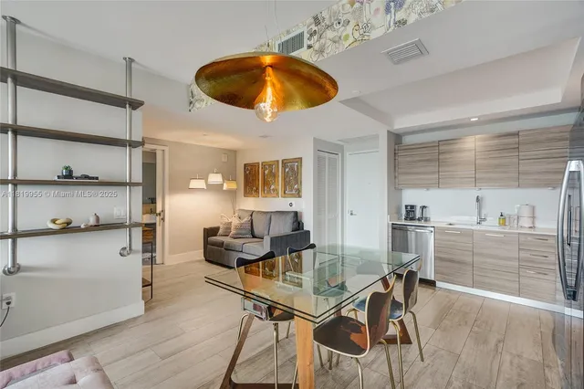 a view of a dining room with furniture and chandelier
