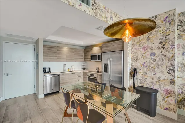 a kitchen with stainless steel appliances a stove a refrigerator and cabinets
