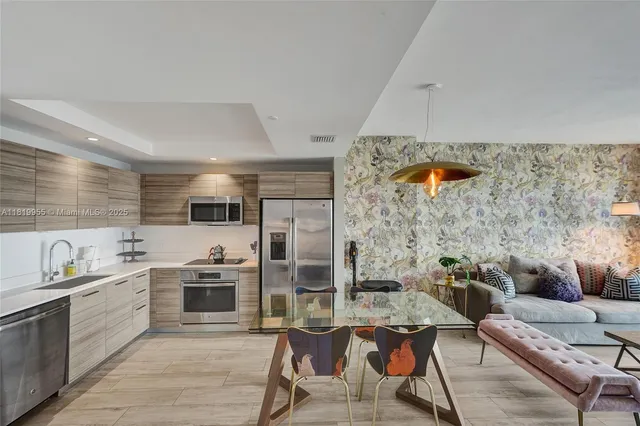 a kitchen with stainless steel appliances kitchen island granite countertop a sink and cabinets