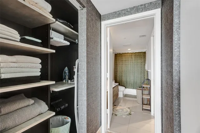 a view of hallway with livingroom and furniture