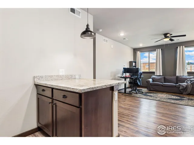 a view of living room with granite countertop furniture and wooden floor