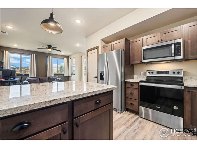 a kitchen with stainless steel appliances granite countertop a stove a microwave and a sink