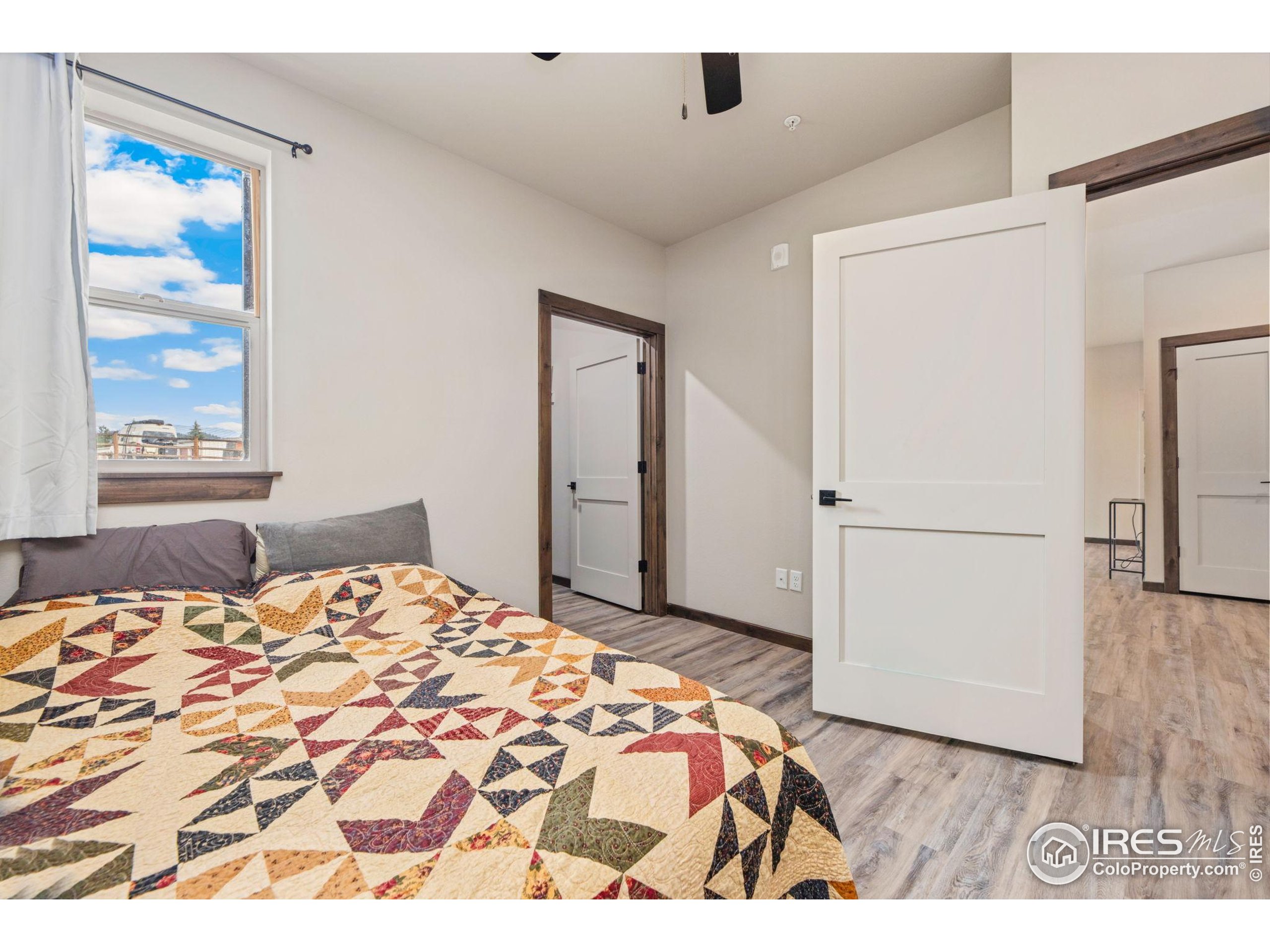 1734 Wildfire Road, Unit 102 Estes Park, CO 80517 - Photo 22 of 33 a bedroom with a bed and a dresser