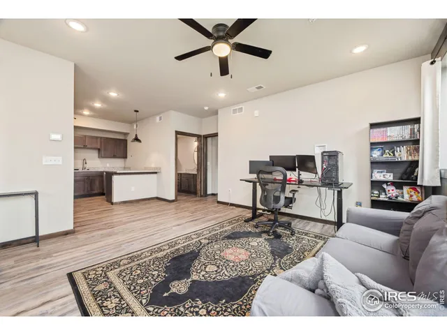 a living room with furniture and kitchen view