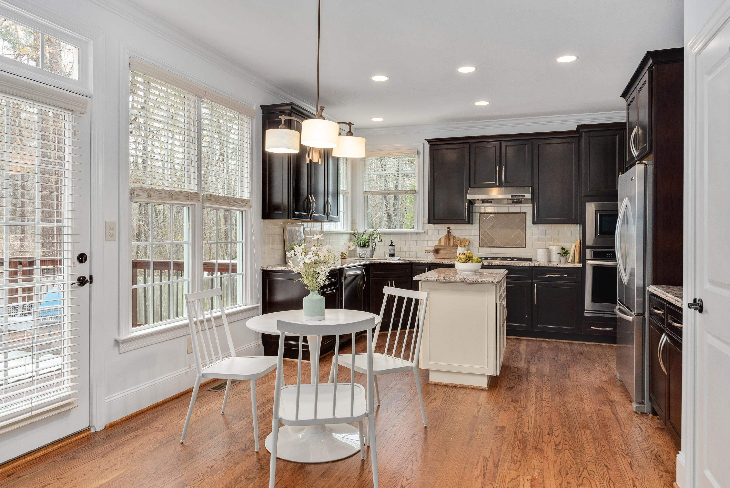 8031 Sundance Circle Durham, NC 27713 - Photo 8 of 35 a view of kitchen with refrigerator and wooden floor