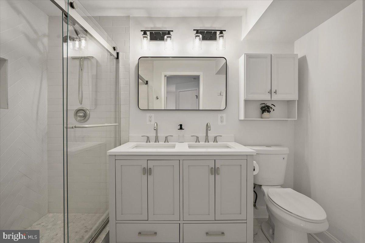 10302 Conover Drive Silver Spring, MD 20902 - Photo 17 of 44 a bathroom with a sink a toilet and shower