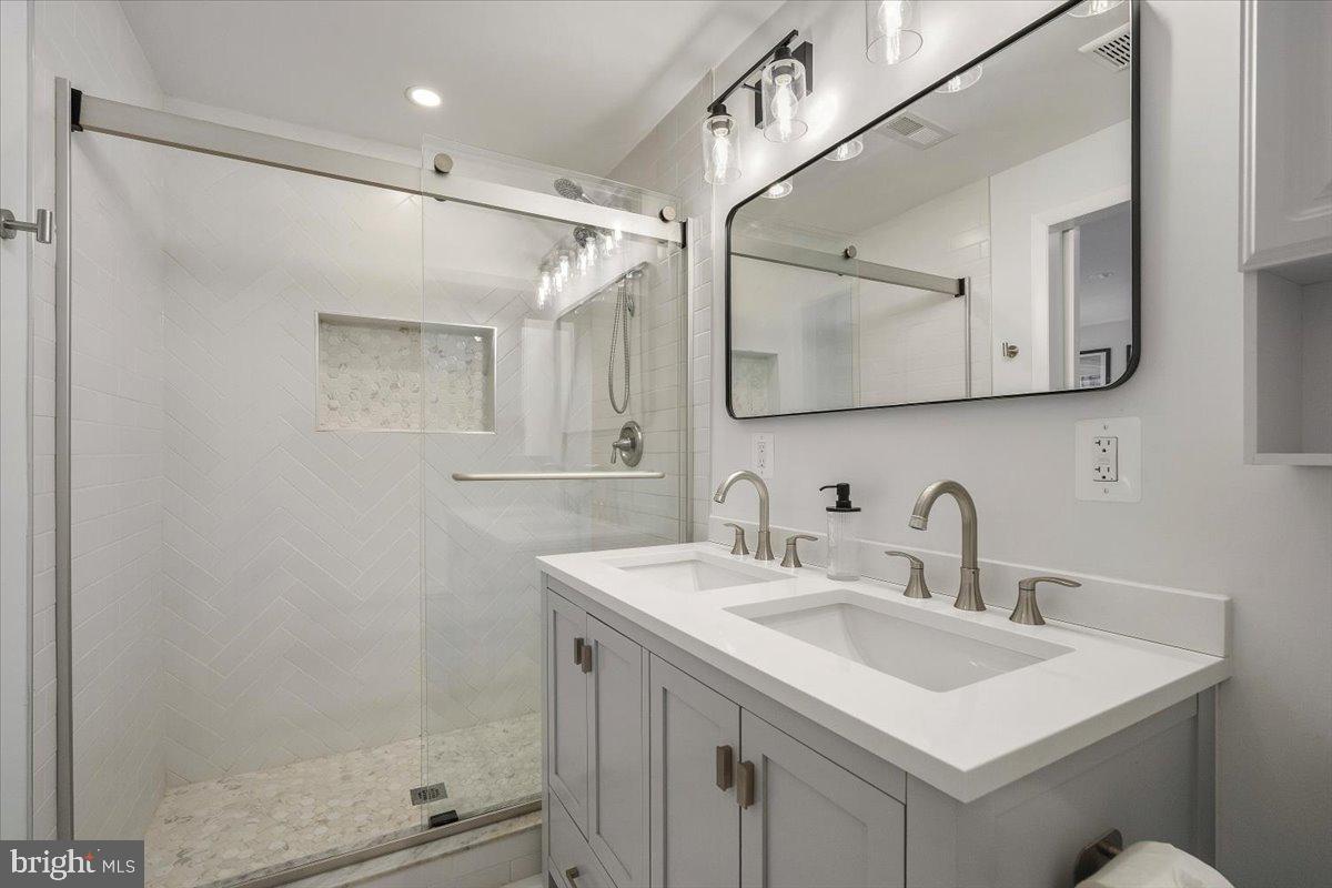 10302 Conover Drive Silver Spring, MD 20902 - Photo 18 of 44 a bathroom with a sink mirror and a shower