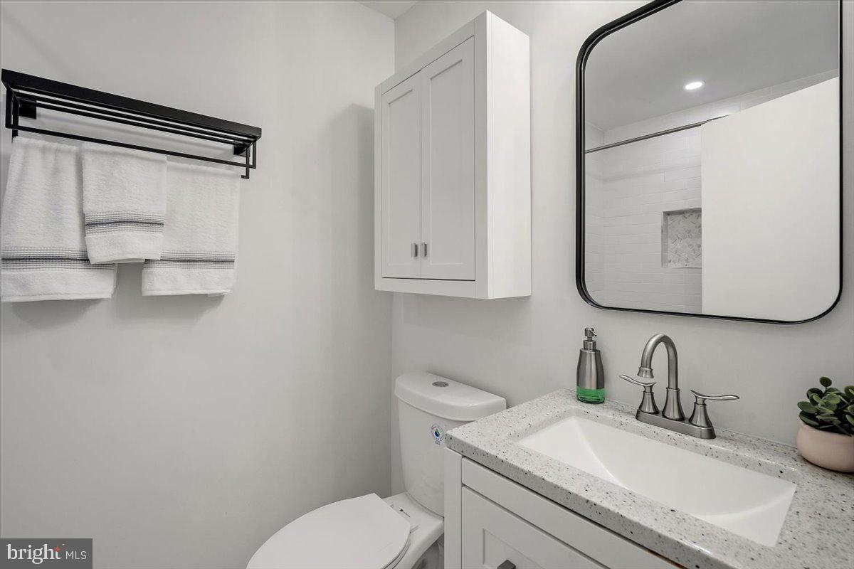 10302 Conover Drive Silver Spring, MD 20902 - Photo 27 of 44 a bathroom with a granite countertop sink mirror vanity and toilet