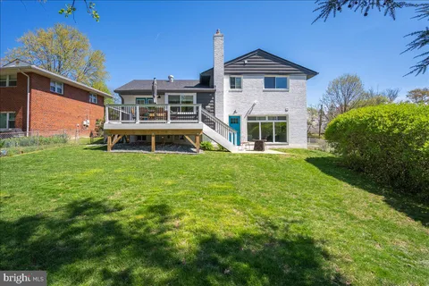 a view of a house with backyard porch and sitting area