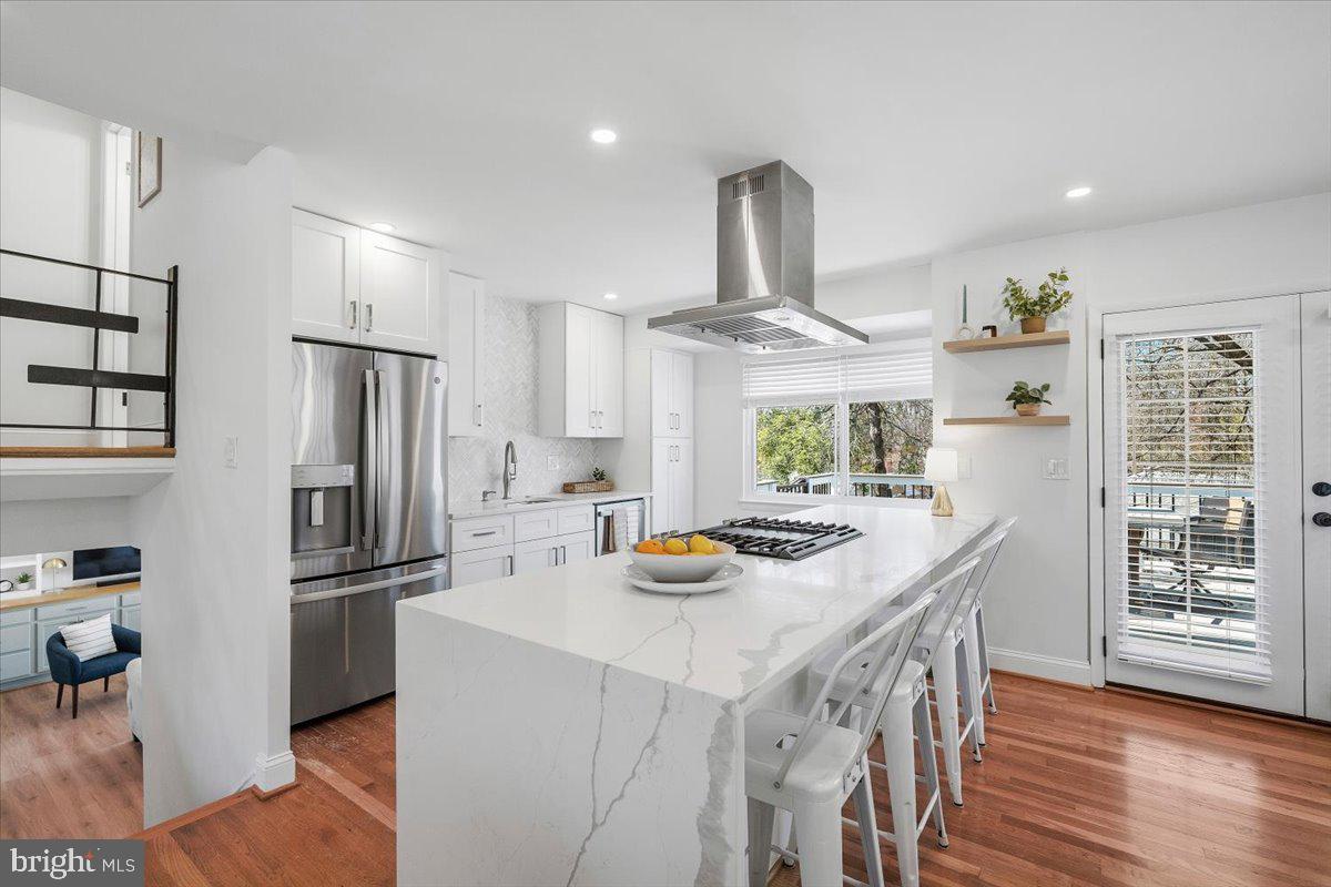 10302 Conover Drive Silver Spring, MD 20902 - Photo 6 of 44 a kitchen with stainless steel appliances a dining table and chairs