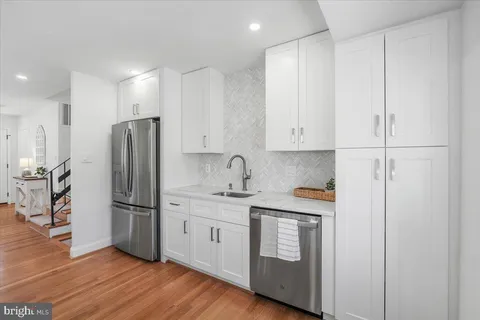 a kitchen with stainless steel appliances a sink a stove and refrigerator