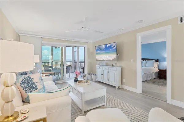 a kitchen with stainless steel appliances kitchen island a chandelier and a view of living room