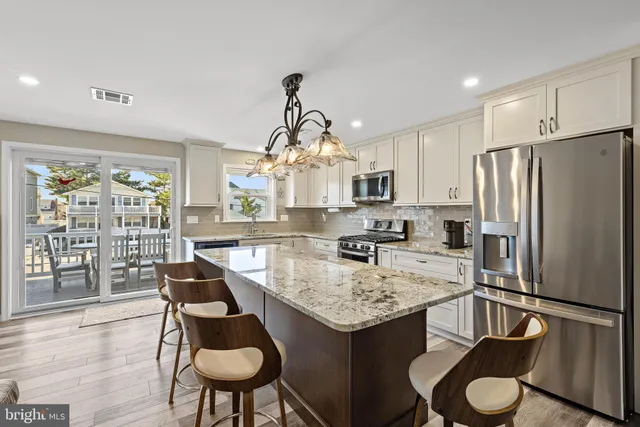 a kitchen with refrigerator cabinets dining table and chairs