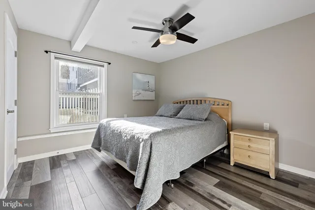 a living room with furniture a flat screen tv and kitchen view