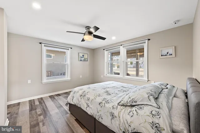 a bathroom with a granite countertop sink a mirror a shower and a bathtub
