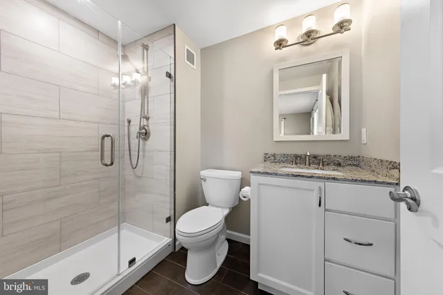 a bedroom with a bed and a ceiling fan