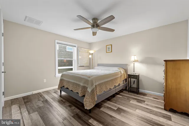 a bathroom with a granite countertop sink a toilet and a mirror